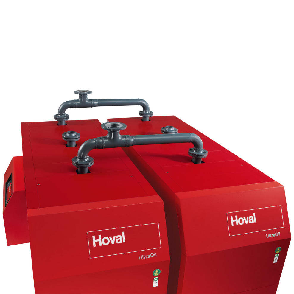 Top view of wwo red Hoval industrial boilers connected by metal pipes on the top set on a white background