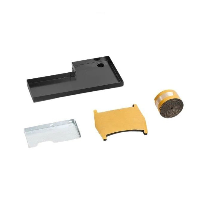 Set of various pieces making up a kit, including a black tray, silver metal piece, brown roll, and brown cut out piece on a white background.