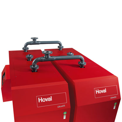 Top view of wwo red Hoval industrial boilers connected by metal pipes on the top set on a white background